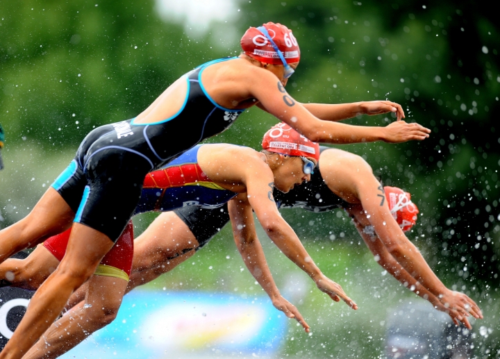 In-this-photo-released-by-the-International-Triathlon-Union-women-dive-into-the-Serpentine-at-the-2009-Triathlon-ITU-World-Championship-Series-in-London-af5