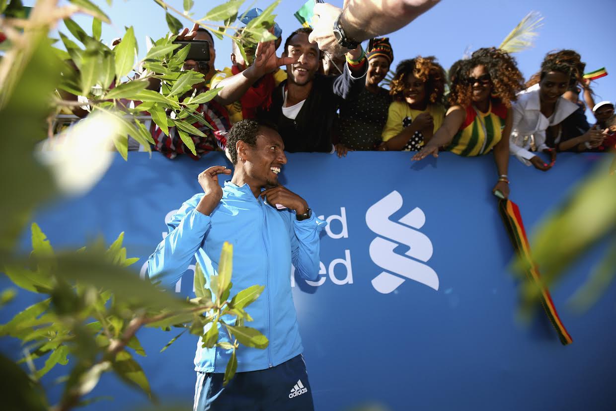 DUBAI, UNITED ARAB EMIRATES - JANUARY 23: Lemi Berhanu Hayle of Ethiopia celebrates with fans after winning the Men's marathon during the Standard Chartered Dubai Marathon on January 23, 2015 in Dubai, United Arab Emirates. (Photo by Francois Nel/Getty Images)
