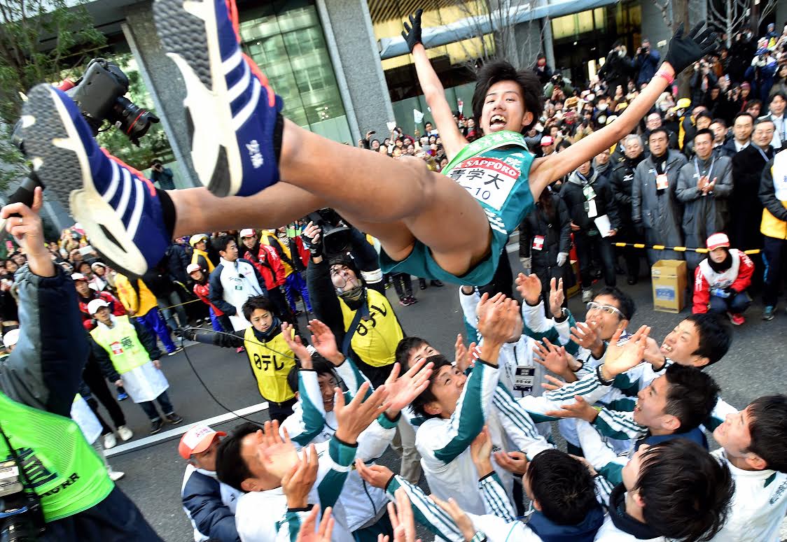 TOKYO, JAPAN - JANUARY 03: (CHINA OUT, SOUTH KOREA OUT) The 10th and final runner of the Aoyama Gakuin University Yuya Ando is thrown into the air by his teammates to celebrate winning in the 91st Hakone Ekiden on January 3, 2015 in Tokyo, Japan. (Photo by The Asahi Shimbun via Getty Images)